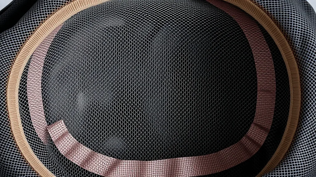Close-up of the interior of a capless wig showing wefts sewn onto elastic bands and open spaces